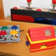 Some LEGO-Parts I use in my Raspberry Pi project group: On the left and right are retainers for Arcade Buttons, in the middle is a LEGO case.